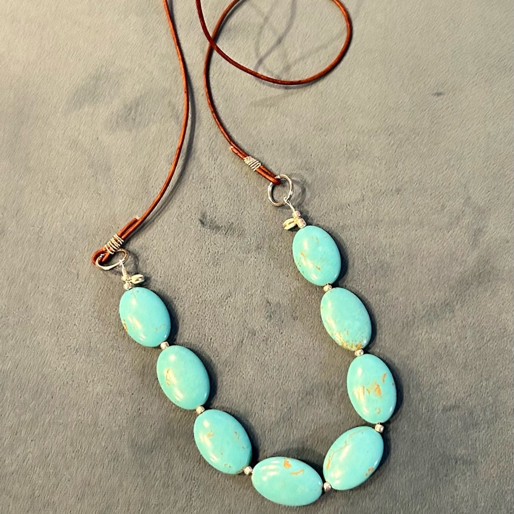 Turquoise and leather handmade necklace. 24’ in length. Can customize.